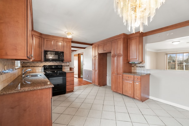 kitchen with sink, tasteful backsplash, light tile patterned floors, dark stone countertops, and black appliances