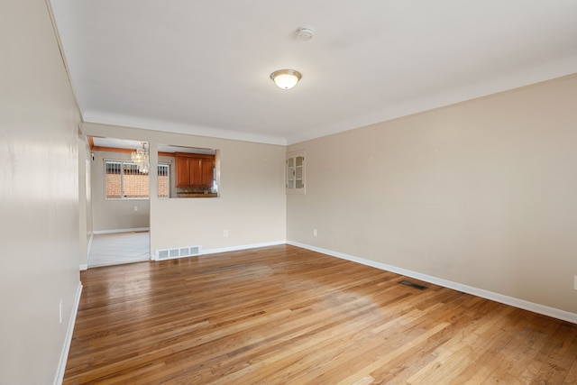 spare room featuring light hardwood / wood-style floors