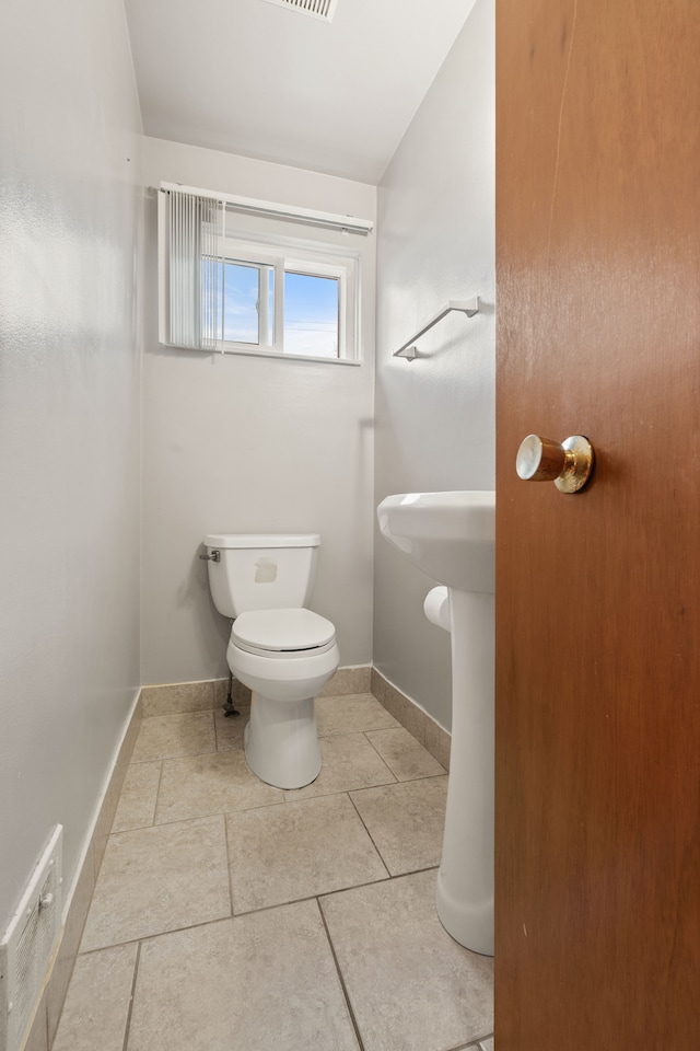 bathroom featuring tile patterned flooring and toilet