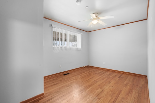 unfurnished room with ornamental molding, light hardwood / wood-style floors, and ceiling fan