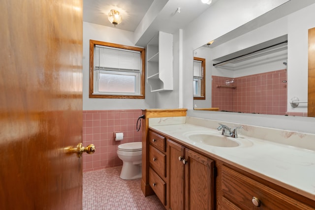 bathroom featuring vanity, tile walls, tile patterned floors, and toilet