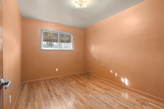 empty room with light hardwood / wood-style flooring