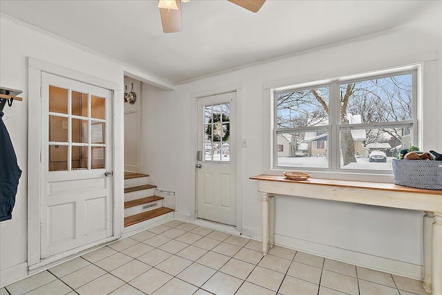 doorway with ceiling fan, plenty of natural light, light tile patterned floors, and ornamental molding