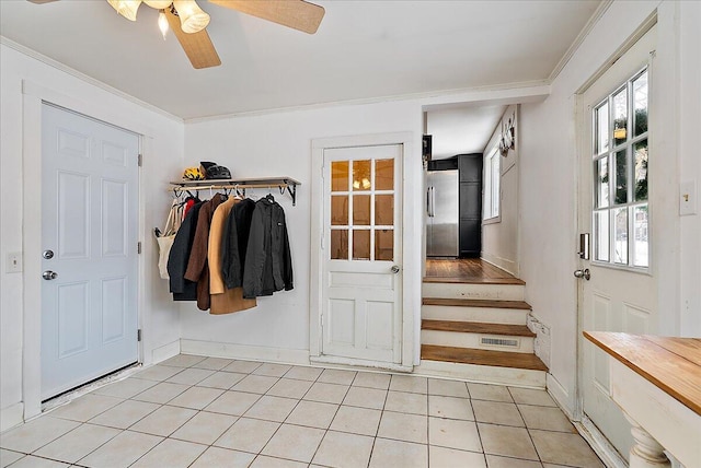 mudroom with ceiling fan, light tile patterned floors, and crown molding