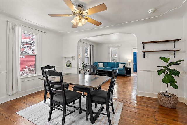 dining area with ceiling fan and wood-type flooring