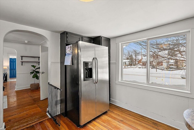 kitchen with hardwood / wood-style flooring and stainless steel fridge