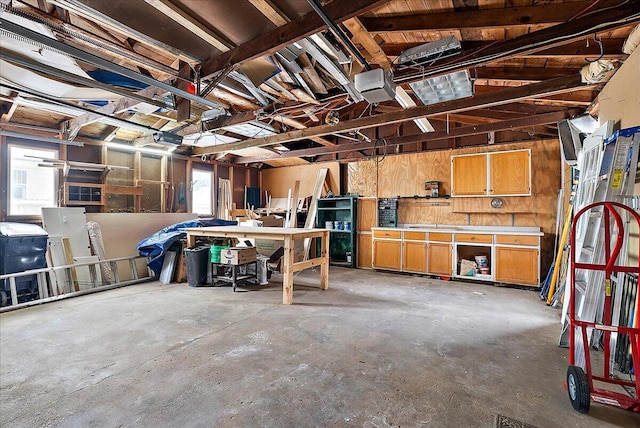 garage featuring a garage door opener and a workshop area