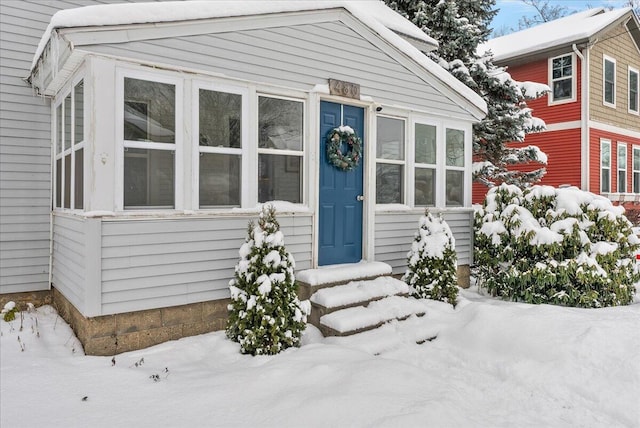 view of snow covered property entrance