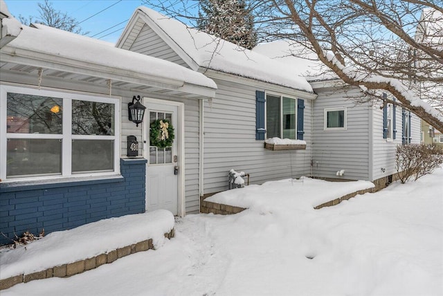 view of snow covered property entrance