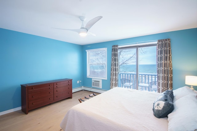 bedroom featuring ceiling fan, access to exterior, light hardwood / wood-style flooring, and a water view