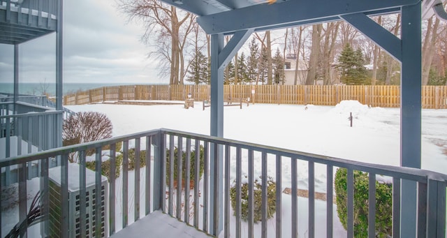 view of snow covered back of property