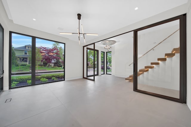 unfurnished room with an inviting chandelier