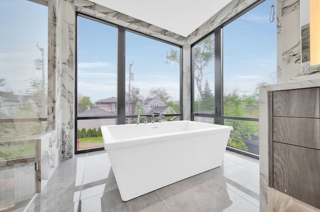 bathroom with a wall of windows and a tub