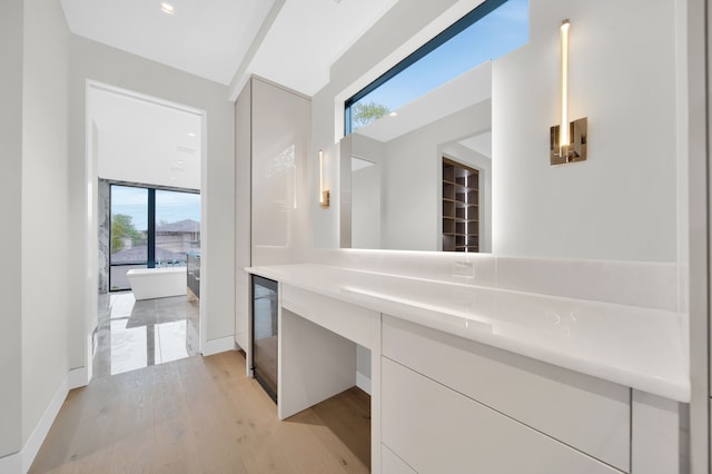 bathroom featuring vanity, beverage cooler, and hardwood / wood-style floors