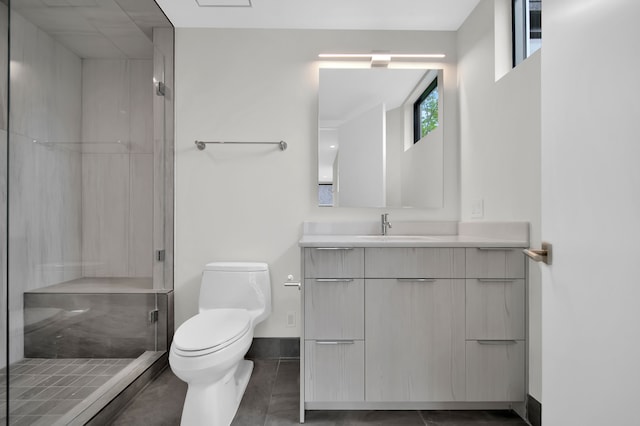 bathroom featuring tile patterned floors, toilet, vanity, and an enclosed shower