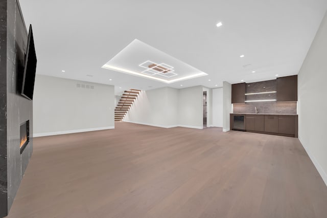 unfurnished living room featuring a large fireplace and light wood-type flooring