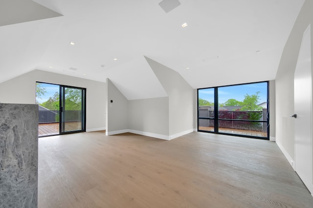 bonus room featuring light hardwood / wood-style floors and vaulted ceiling