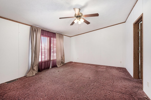 carpeted empty room with ceiling fan, crown molding, and a textured ceiling