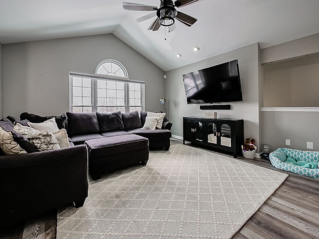 living room with vaulted ceiling, ceiling fan, and light wood-type flooring