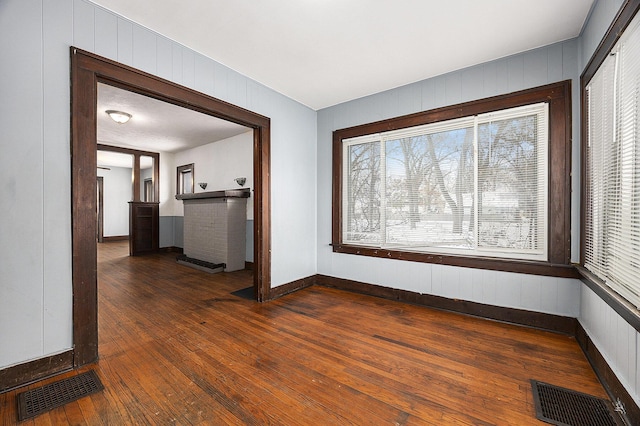 empty room with dark hardwood / wood-style flooring