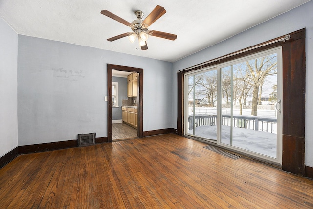 spare room with ceiling fan and wood-type flooring