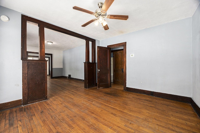 empty room with ceiling fan and dark hardwood / wood-style floors