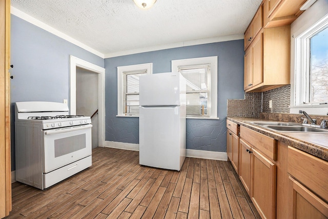 kitchen with white appliances, a textured ceiling, tasteful backsplash, sink, and light wood-type flooring