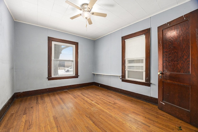 unfurnished room with ceiling fan, hardwood / wood-style flooring, and ornamental molding