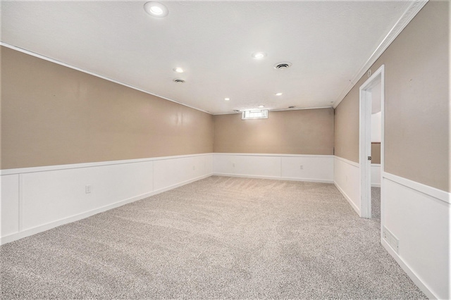 empty room featuring light carpet and ornamental molding