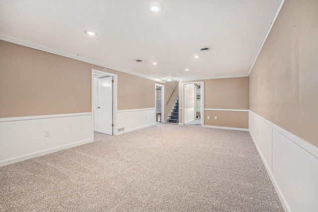 spare room featuring crown molding and carpet flooring