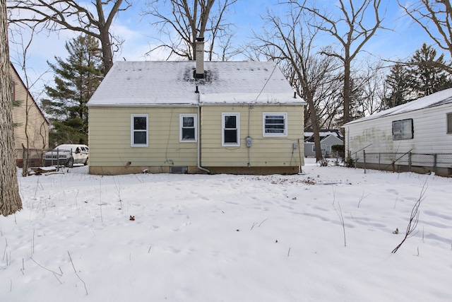 view of snow covered rear of property