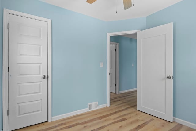 unfurnished bedroom with ceiling fan and light hardwood / wood-style floors