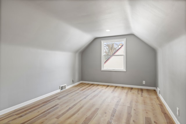 bonus room featuring lofted ceiling and light hardwood / wood-style floors