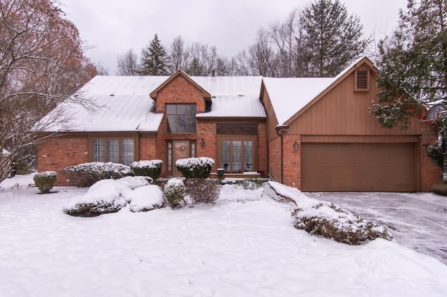 view of front facade with a garage and french doors