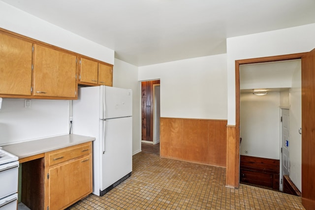 kitchen with wooden walls and white appliances