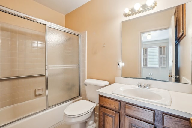 full bathroom with toilet, enclosed tub / shower combo, and vanity