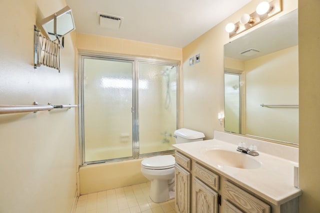 full bathroom with tile patterned floors, enclosed tub / shower combo, vanity, and toilet