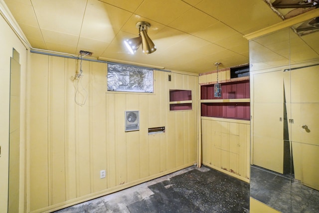 basement featuring wood walls