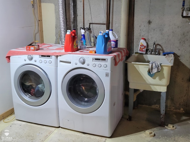 clothes washing area with sink and washing machine and dryer