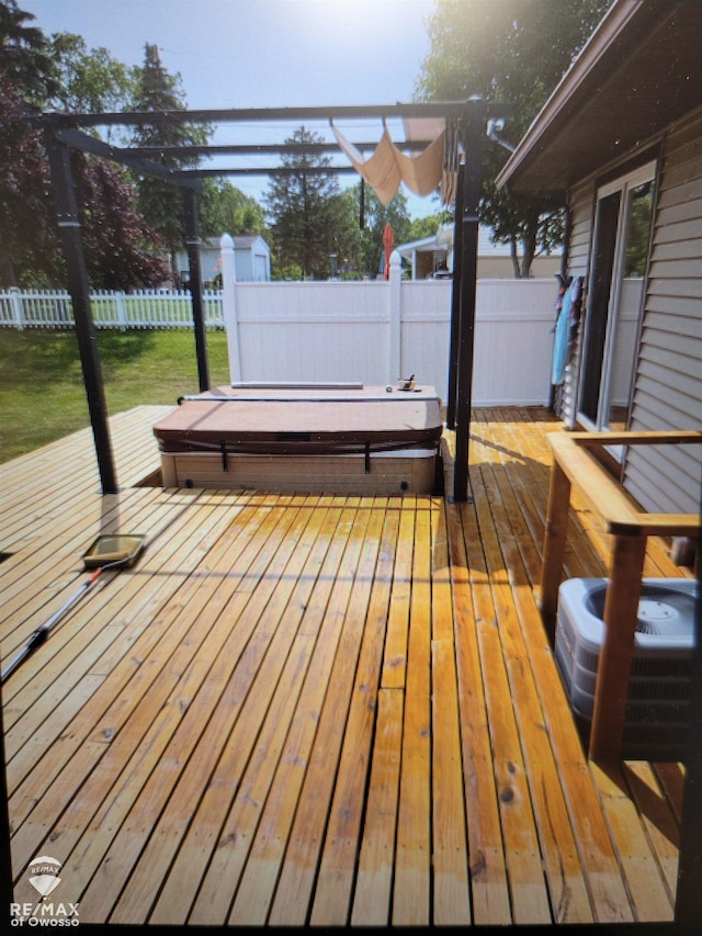 wooden deck featuring a covered hot tub