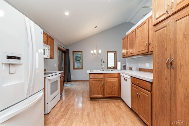 kitchen featuring kitchen peninsula, decorative light fixtures, white appliances, lofted ceiling, and sink