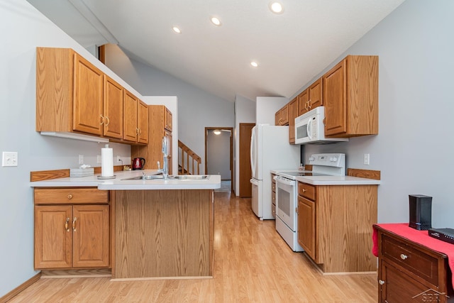 kitchen with white appliances, lofted ceiling, sink, kitchen peninsula, and light wood-type flooring