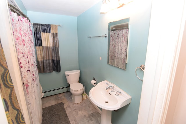 bathroom with toilet, baseboard heating, and sink