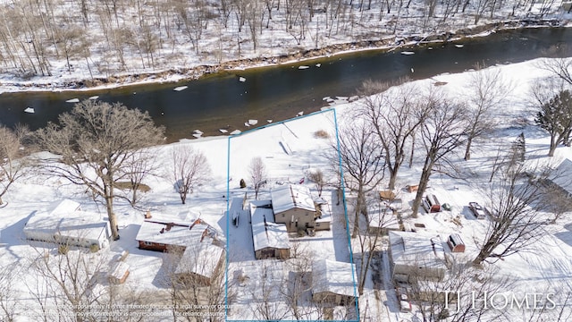 snowy aerial view featuring a water view