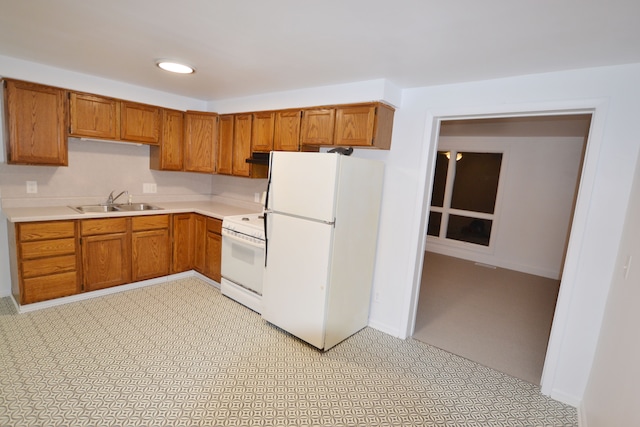 kitchen featuring sink and white appliances