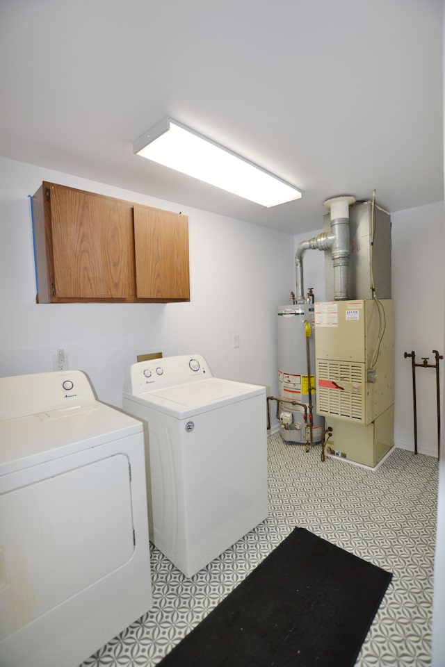 laundry room with water heater, cabinets, washing machine and dryer, and heating unit