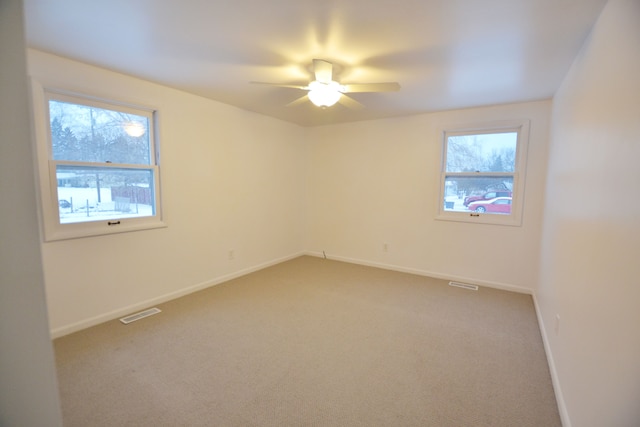 carpeted empty room featuring ceiling fan