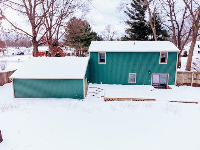 view of snow covered back of property