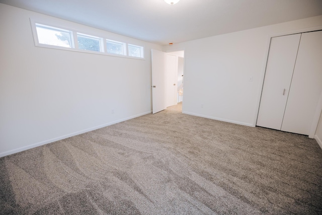 unfurnished bedroom featuring a closet and carpet flooring