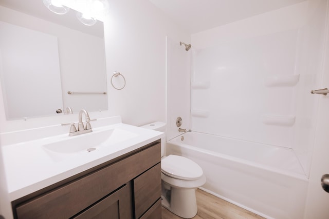 full bathroom featuring toilet, shower / washtub combination, hardwood / wood-style floors, and vanity